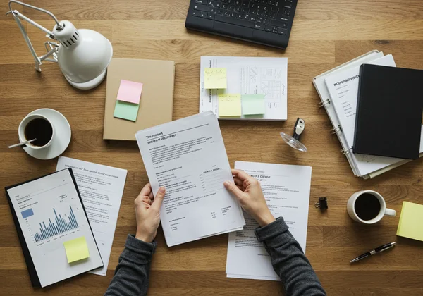 Person organizing documents for a neurodivergent assessment